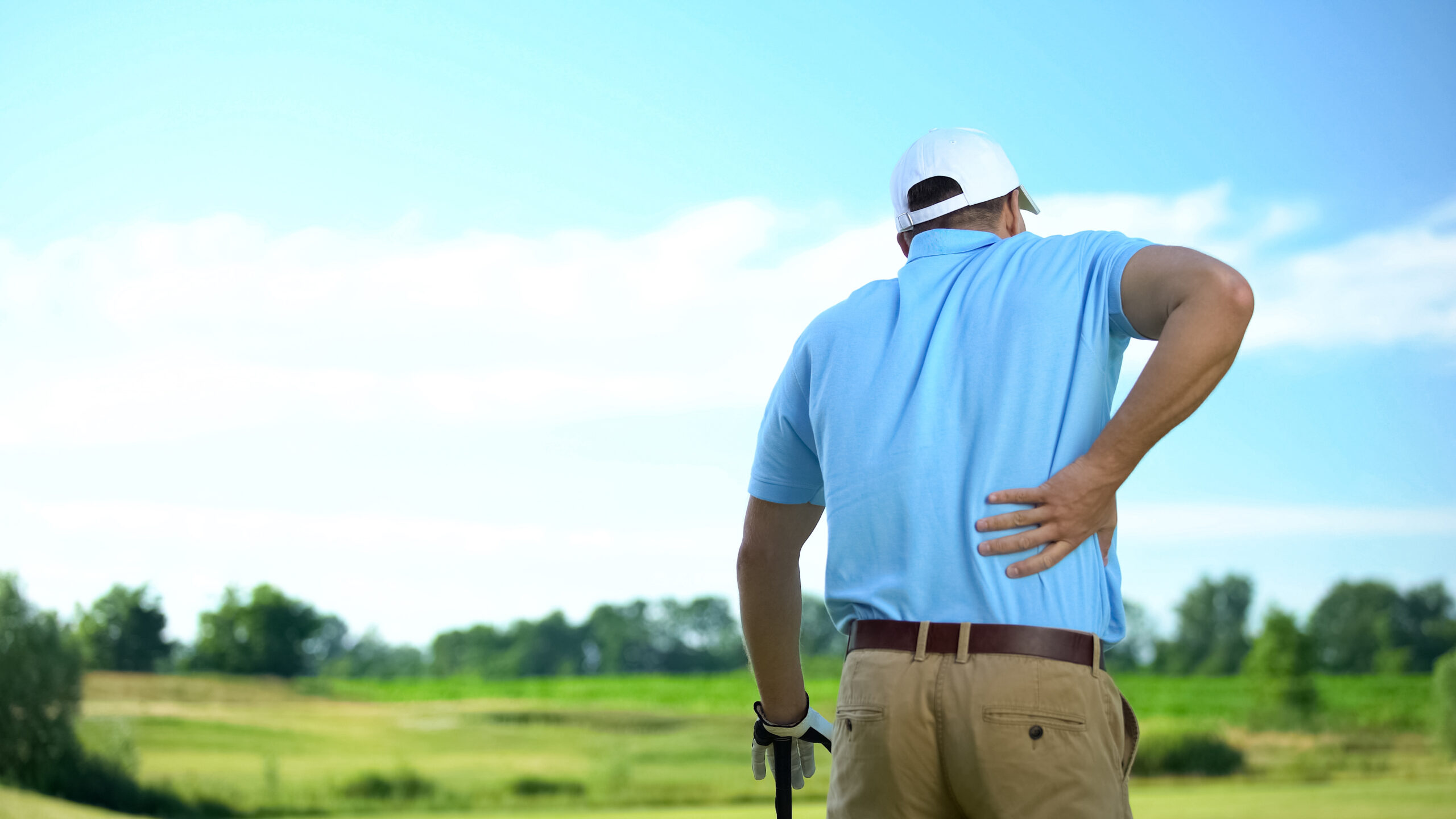 Golfer with low back pain  and sciatic aafter hitting a golf ball