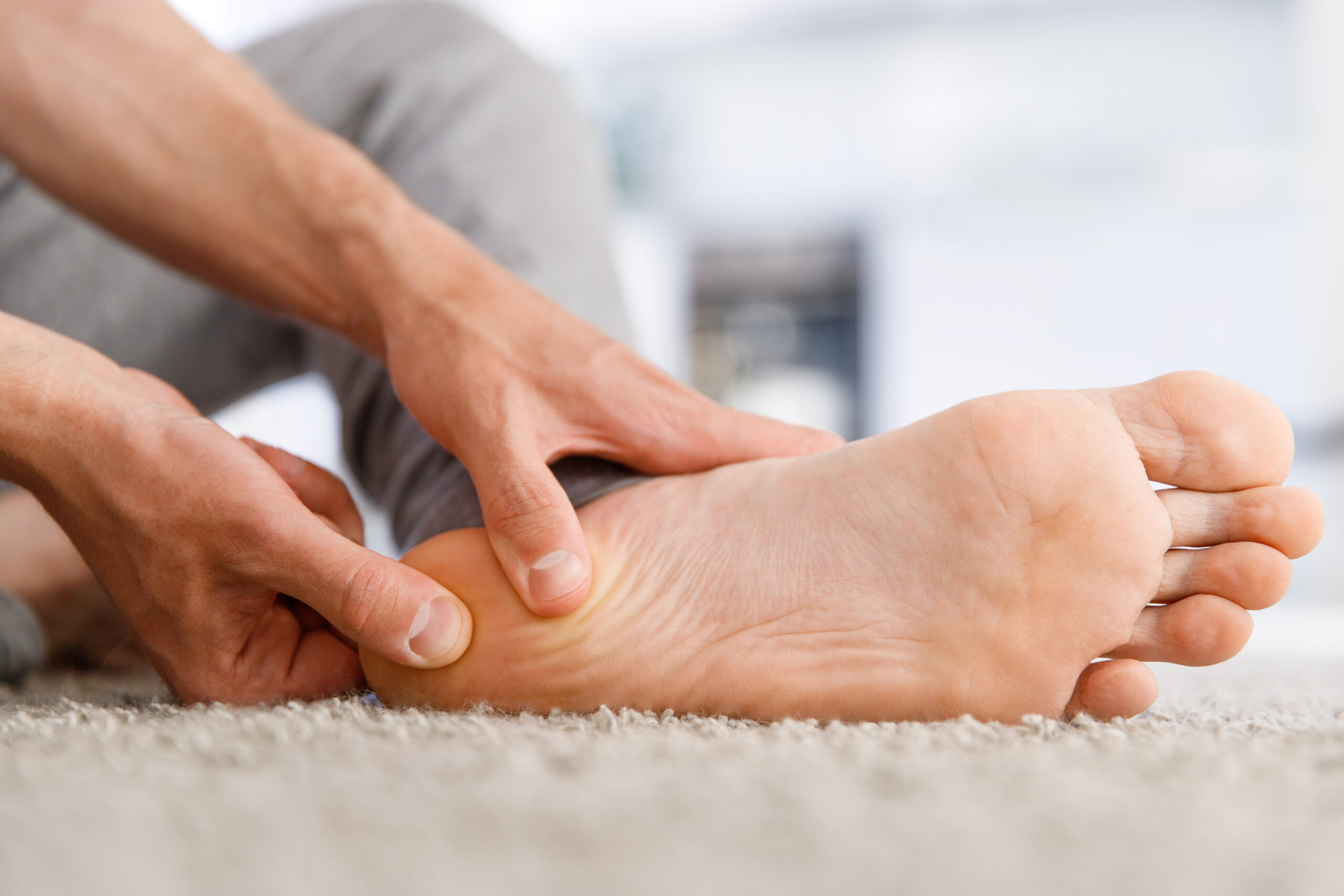 person with heel pain from Plantar Fasciitis